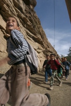 School children running to school.