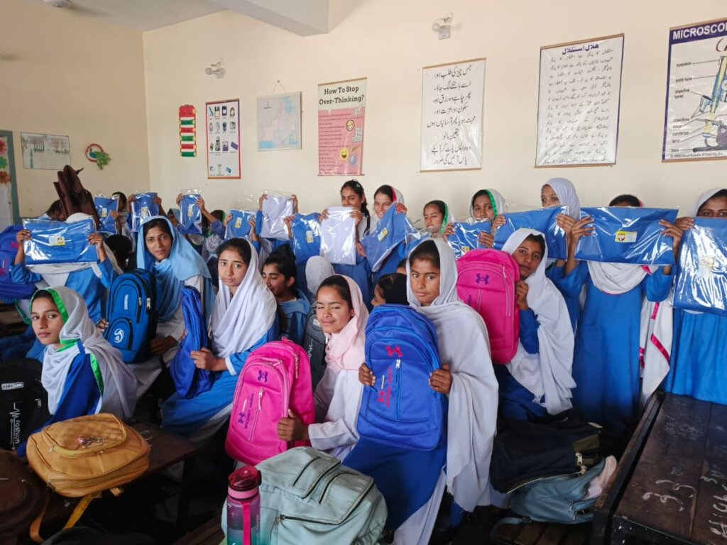 Students receiving their uniforms and school bags
