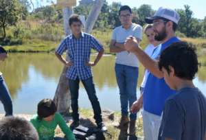 Samuel explaining how to handle the tilapia