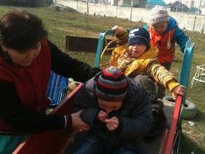 Akylbek enjoys the slide with his friends