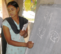 A schoolteacher in a classroom funded by NYOF