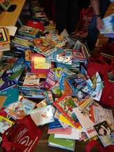 Piles of donated books being sorted
