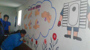 A student paints messages on Menstrual Hygiene Day