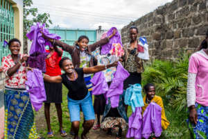 Our proud mothers displaying their first uniforms.