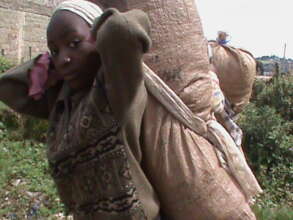 Children carrying charcoal to the market