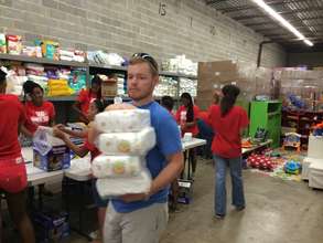 Volunteers repackaging diapers in a diaper bank