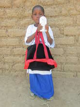 Ouedraogo Bata with her school supplies & lamp
