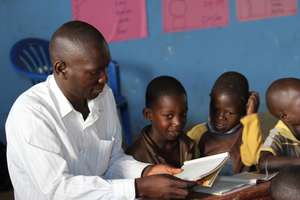 Headmaster George grading papers