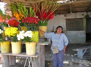 Selinita stands with her flower stand.
