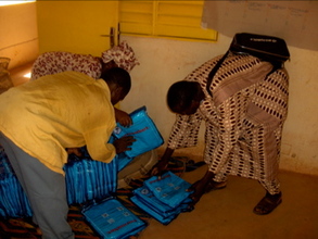 Tenignini, the Alliance's local Health Coordinator, distributes
