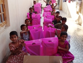children displaying examination pads happily