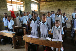Students in their classroom with donated books.