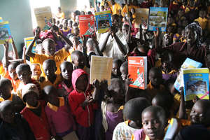 Students at Ruiyobei Primary receiving books