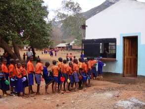 Pupils being served food at Jora Primary School