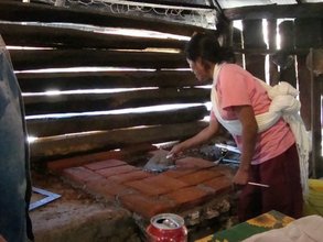 A woman participates in the construction of a fuel efficient sto