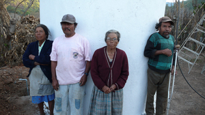 Don Tino and is family next to the rainwater cistern