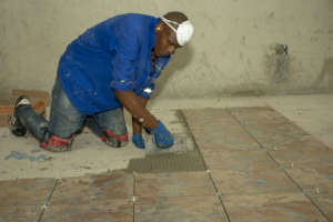 A local man doing tiling at the guest house