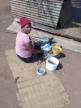 A 'Make' (mother in siSwati) cracks marula nuts
