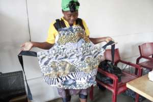 Nonhlanhla modeling an apron she sewed