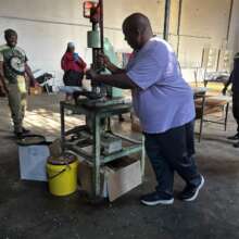 Crushing marula nuts bought from the community