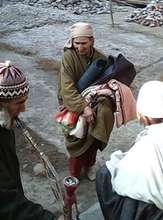 An Old lady taking materials for winter..