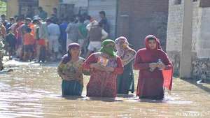 Crossing knee deep water to get needy materials.
