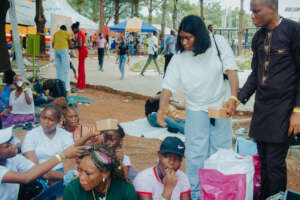 Damilola distributing food at Easter Hangout