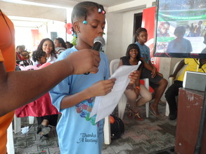Naomi reads her winning essay at the Brunch