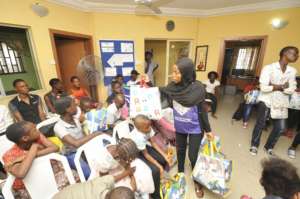 Nishola distributes party packs to the children