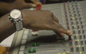 A sound mixing board is adjusted for broadcast.