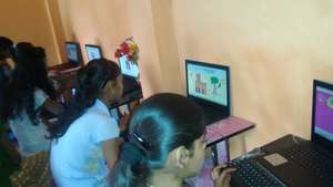 Girls learning to use paint brush