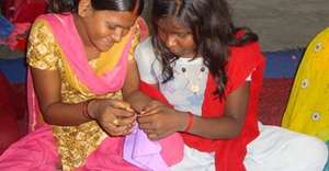 Girls undertaking sewing training