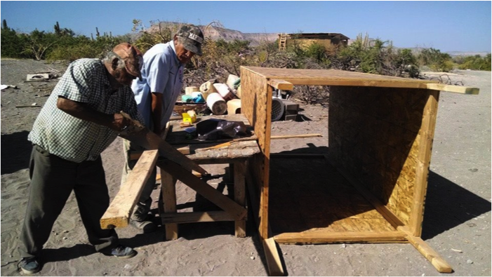 Carlos and Santiago work on a composting toilet