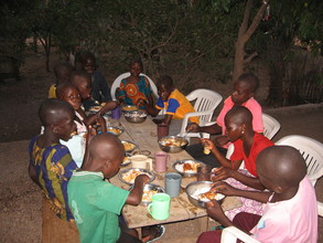 Kids at the transit camp having a meal together