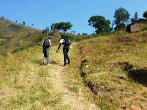 Project Officer going to Kibyo Primary School