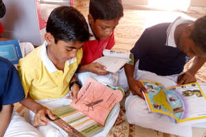 Orphanage boys engaged in new library books