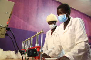 Young girls making sanitary pads for school girls