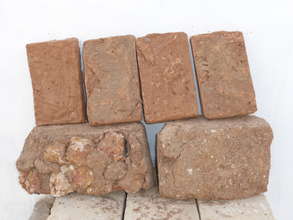 Mud brick with embedded pebbles (lower left)