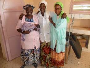 Midwife & nurses with baby
