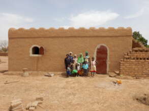 A family in front of their NV house