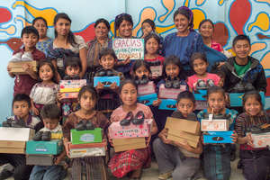 Students and their families receiving their shoes