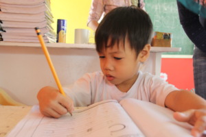 He can now draw and write, sometimes on the walls.