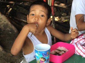 He eats hot packed lunch in school with gusto.