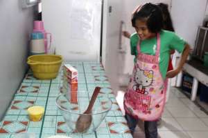 The little chef in the kitchen is all set.