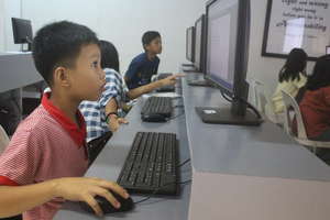CJFI kid doing computer assignment
