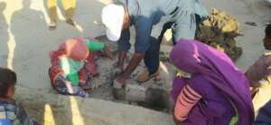 women making cooking stove