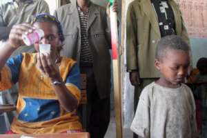 An Orbis-trained nurse measures Abdulmejid's dose