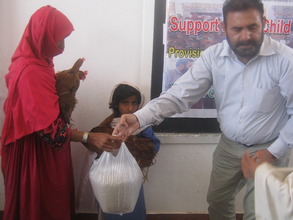 Shazia is receiving Hens and feed for nutritions