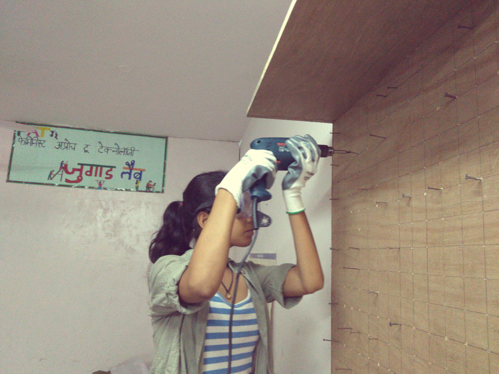 Rubi drills the tool board on to the wall