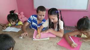 Aaron helping young girl